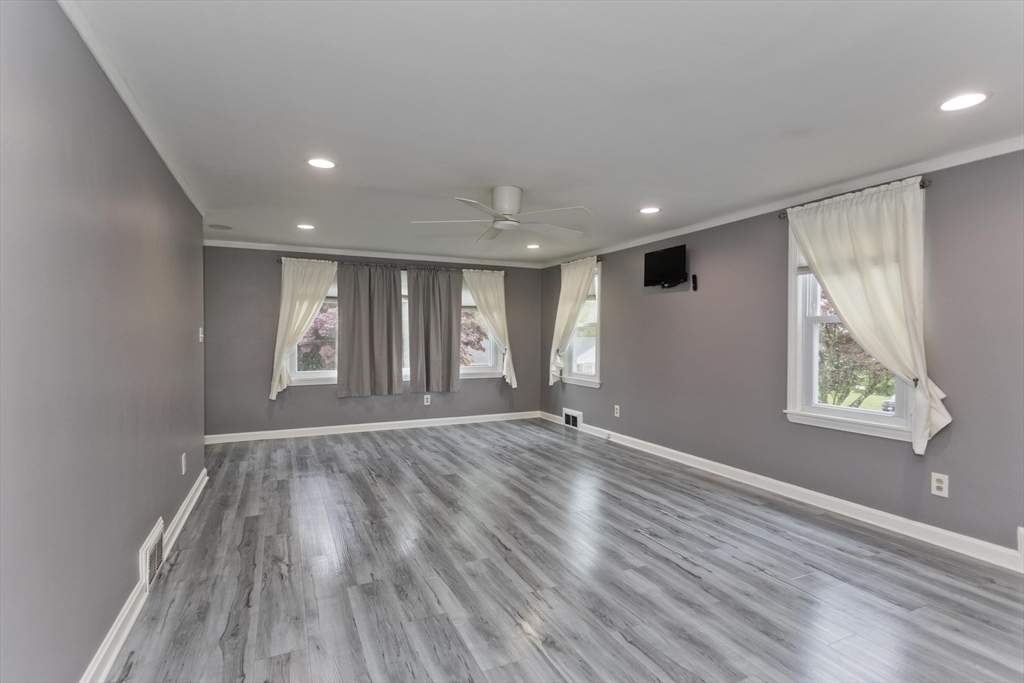 83 Chalmers Street Springfield, MA 01118 - Photo 9 of 40 a view of an empty room with wooden floor and a window