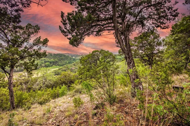 a kitchen with white cabinets and sink
