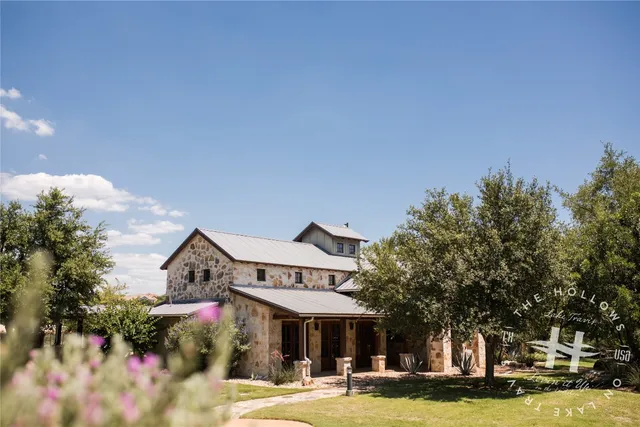 a view of a house with swimming pool and chairs