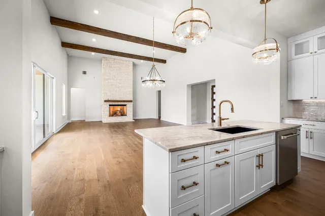 a kitchen with stainless steel appliances a counter space a sink a stove and a window