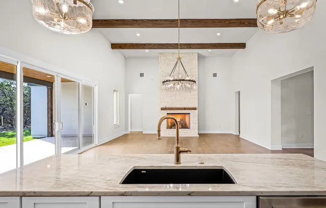a kitchen with sink cabinets and wooden floor