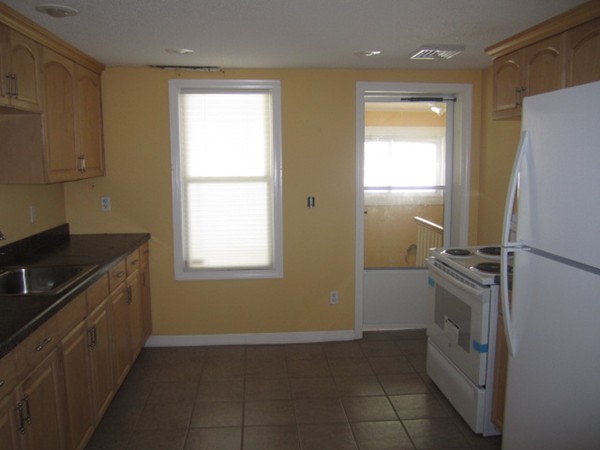 93 Stuart Street Springfield, MA 01119 - Photo 11 of 24 a kitchen with a refrigerator stove and cabinets