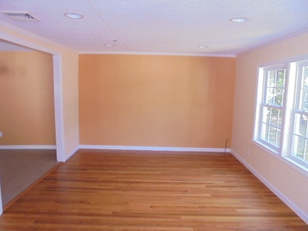 93 Stuart Street Springfield, MA 01119 - Photo 5 of 24 a view of an empty room with wooden floor and a window