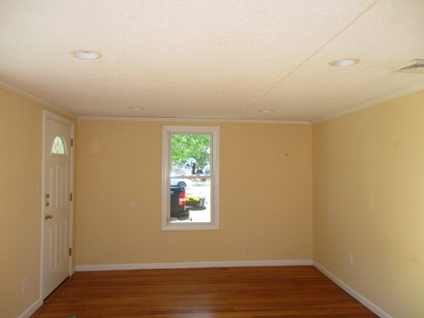93 Stuart Street Springfield, MA 01119 - Photo 6 of 24 an empty room with wooden floor and windows