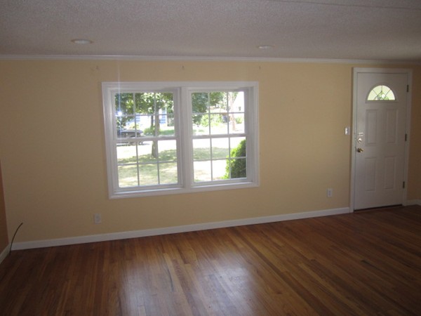 93 Stuart Street Springfield, MA 01119 - Photo 7 of 24 a view of an empty room with wooden floor and a window