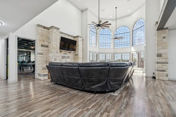 a kitchen with stainless steel appliances kitchen island granite countertop a table chairs sink and cabinets