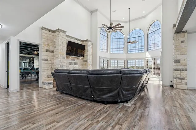 a kitchen with stainless steel appliances kitchen island granite countertop a table chairs sink and cabinets