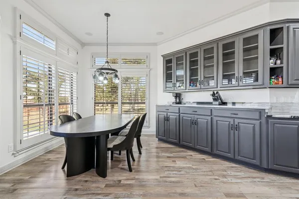 a view of a dining room with furniture large windows and wooden floor