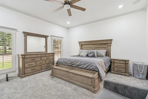 a bedroom with a bed and ceiling fan