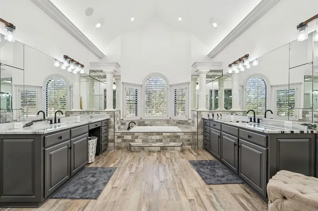 a spacious bedroom with a bed and ceiling fan