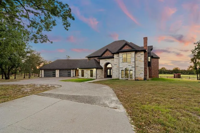 an aerial view of a house with swimming pool and porch