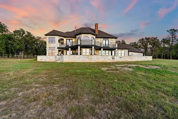 a view of a patio with couches and table and chairs and floor to ceiling window