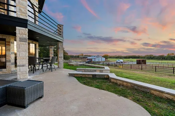 a view of a livingroom with wooden floor and stairs