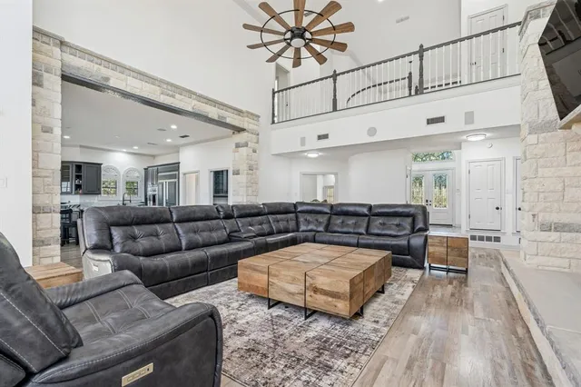 a living room with furniture wooden floor and a flat screen tv
