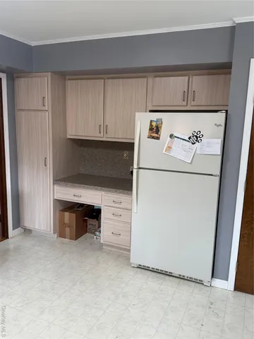 a utility room with cabinets washer and dryer