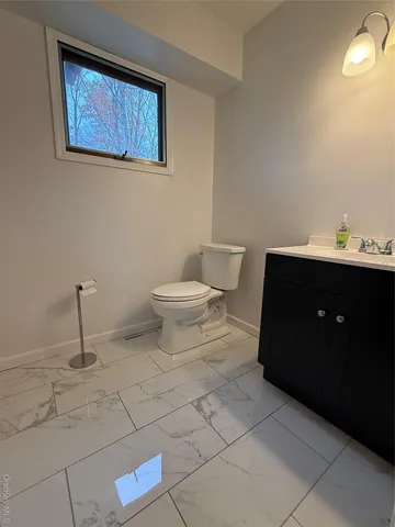 a bathroom with a toilet sink and mirror
