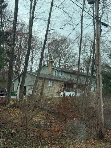 a backyard of a house with lots of green space and lake view