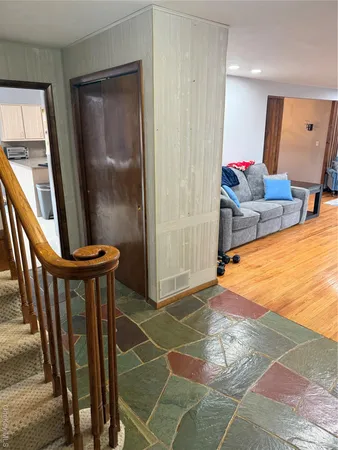 a view of an empty room with a mirror and furniture