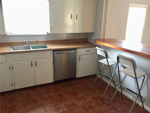 a kitchen with a sink cabinets and white appliances