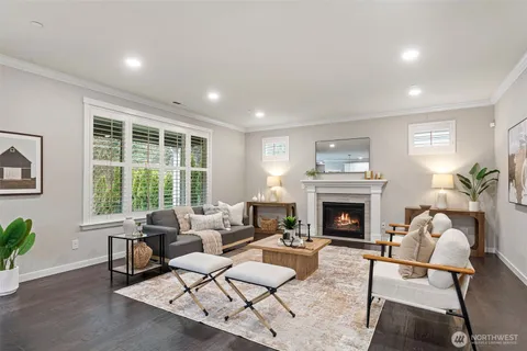 a living room with furniture fireplace and potted plants