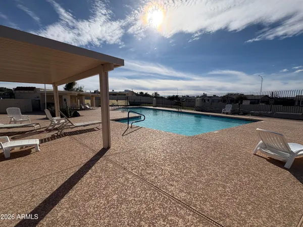 a view of a swimming pool with outdoor seating
