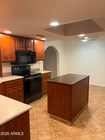 a kitchen with stainless steel appliances granite countertop a stove a sink and a refrigerator