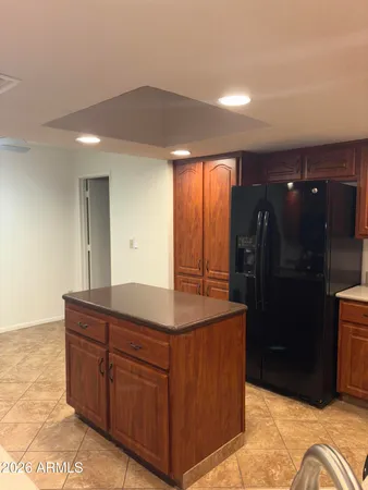 a kitchen with stainless steel appliances granite countertop a refrigerator and a sink