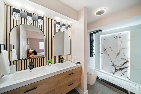 a bathroom with a bathtub a sink and a mirror