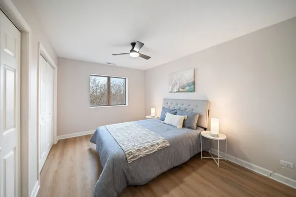 a bedroom with a large bed and a window