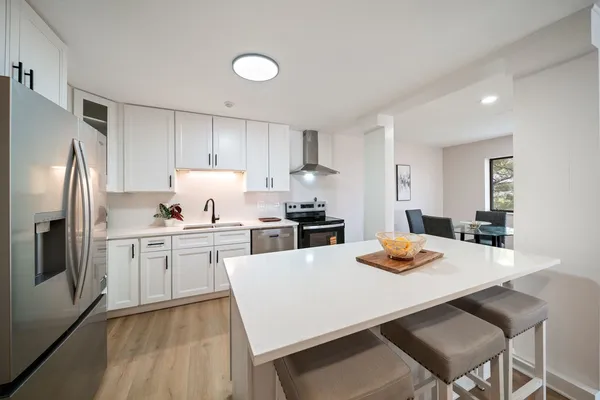 a kitchen with a dining table and chairs