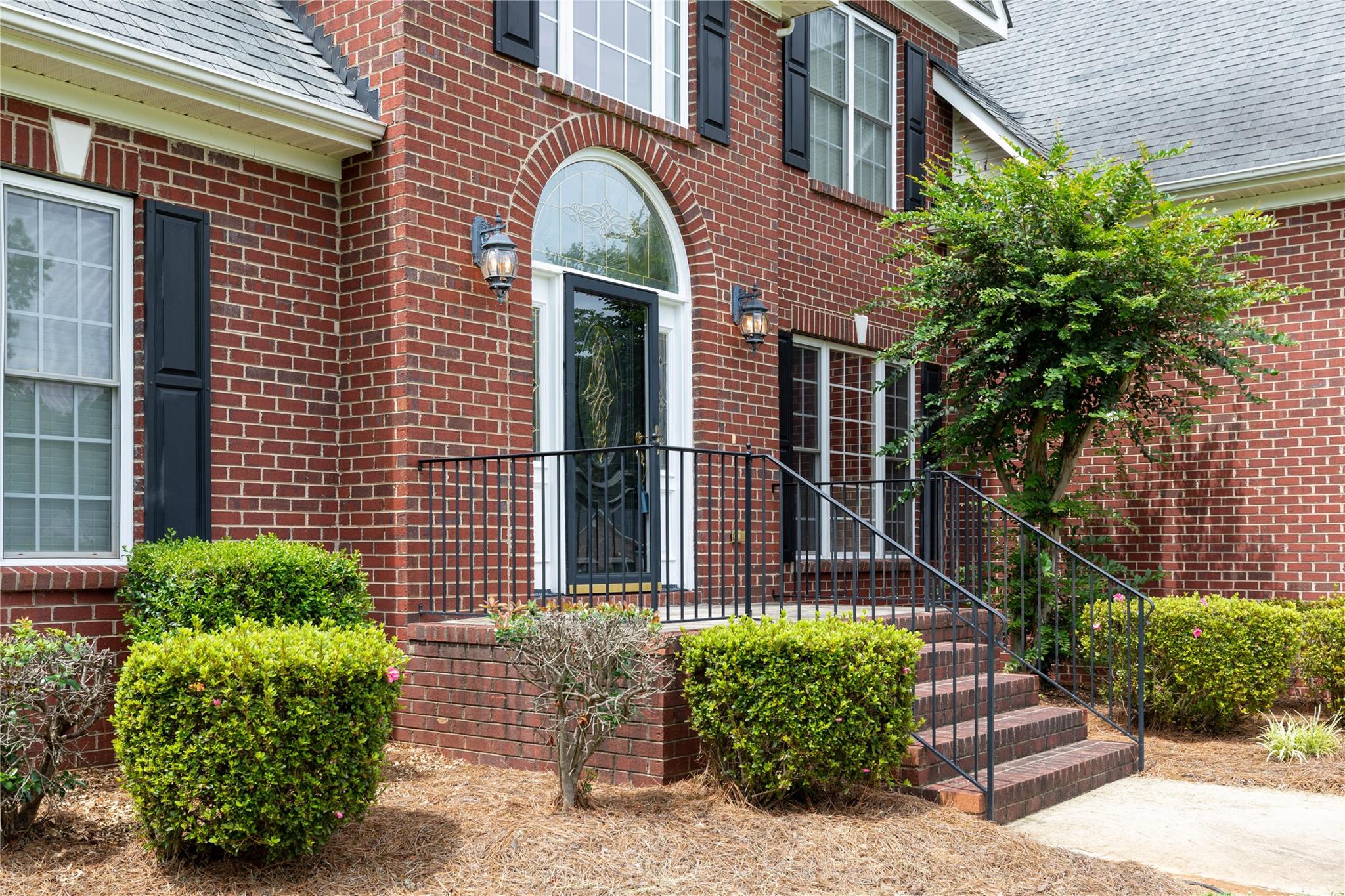 533 Mason Dickson Road York, SC 29745 - Photo 4 of 48 a view of a brick house with plants and large windows