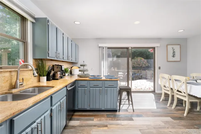 a kitchen with granite countertop a sink and cabinets