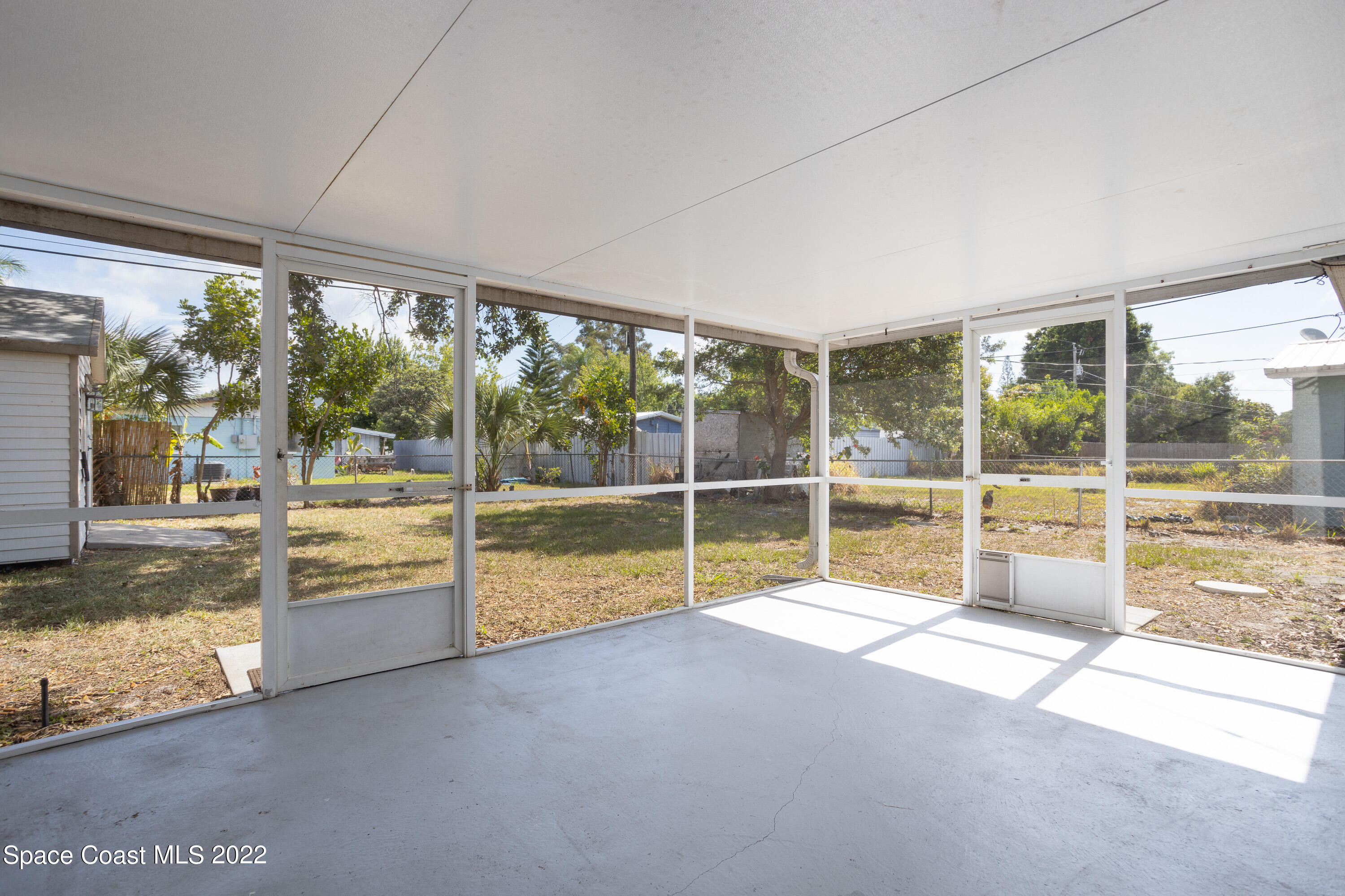 2602 Post Road Melbourne, FL 32935 - Photo 20 of 22 a view of a living room and floor to ceiling window