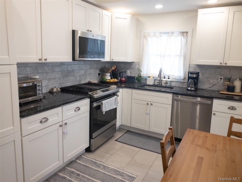 120 Clinton Avenue, Unit 1 Nyack, NY 10960 - Photo 11 of 15 a kitchen with granite countertop white cabinets and white appliances