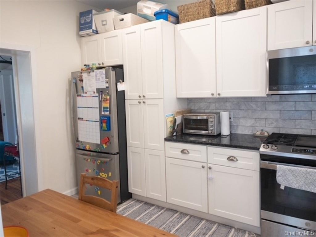 120 Clinton Avenue, Unit 1 Nyack, NY 10960 - Photo 12 of 15 a kitchen with stainless steel appliances granite countertop a refrigerator sink and stove