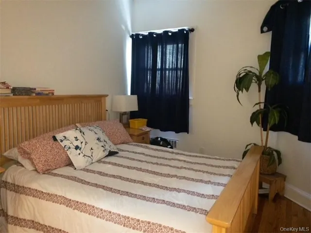 a bedroom with a bed window and flowerpot