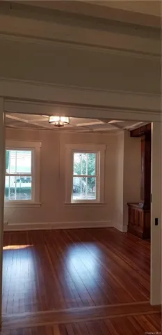 a view of room with window and wooden floor