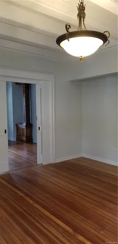 a view of a room with wooden floor and a sink