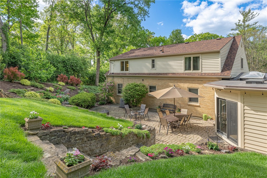 156 West Hadley Road Dayton, OH 45419 - Photo 44 of 71 Enjoy outdoor living with a spacious patio, lush landscaping, and mature trees.