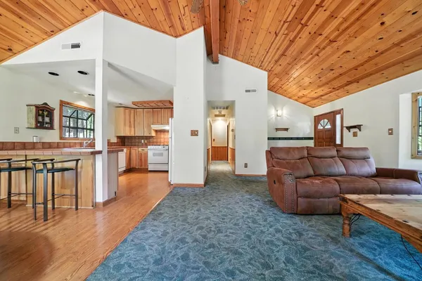 a living room with furniture and a kitchen view