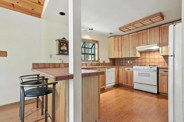 a kitchen with a stove cabinets and a refrigerator