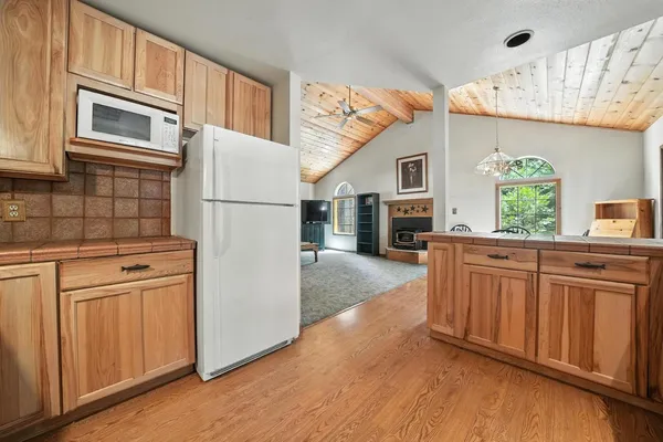 a kitchen with stainless steel appliances granite countertop a refrigerator sink and cabinets