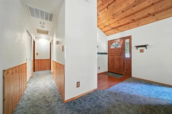 a view of a hallway with wooden shelves