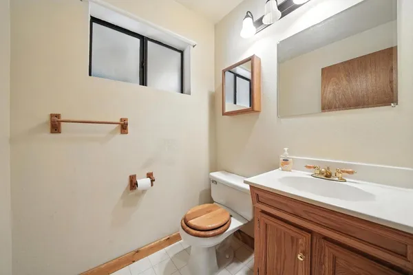 a bathroom with a sink a toilet and a mirror