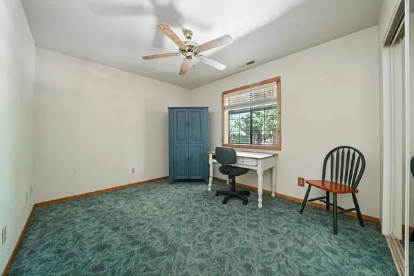a view of a room with a window and furniture