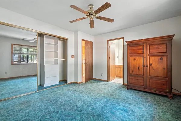 an empty room with windows and closet