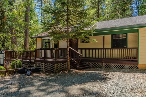 a view of a house with wooden floor fence and a porch