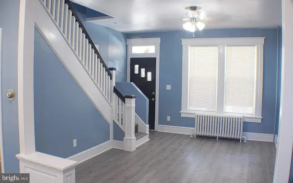 a view of an entryway with wooden floor and staircase