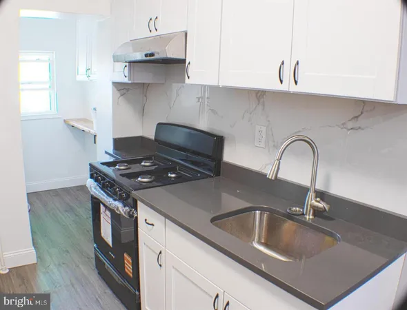 a stove top oven sitting inside of a kitchen