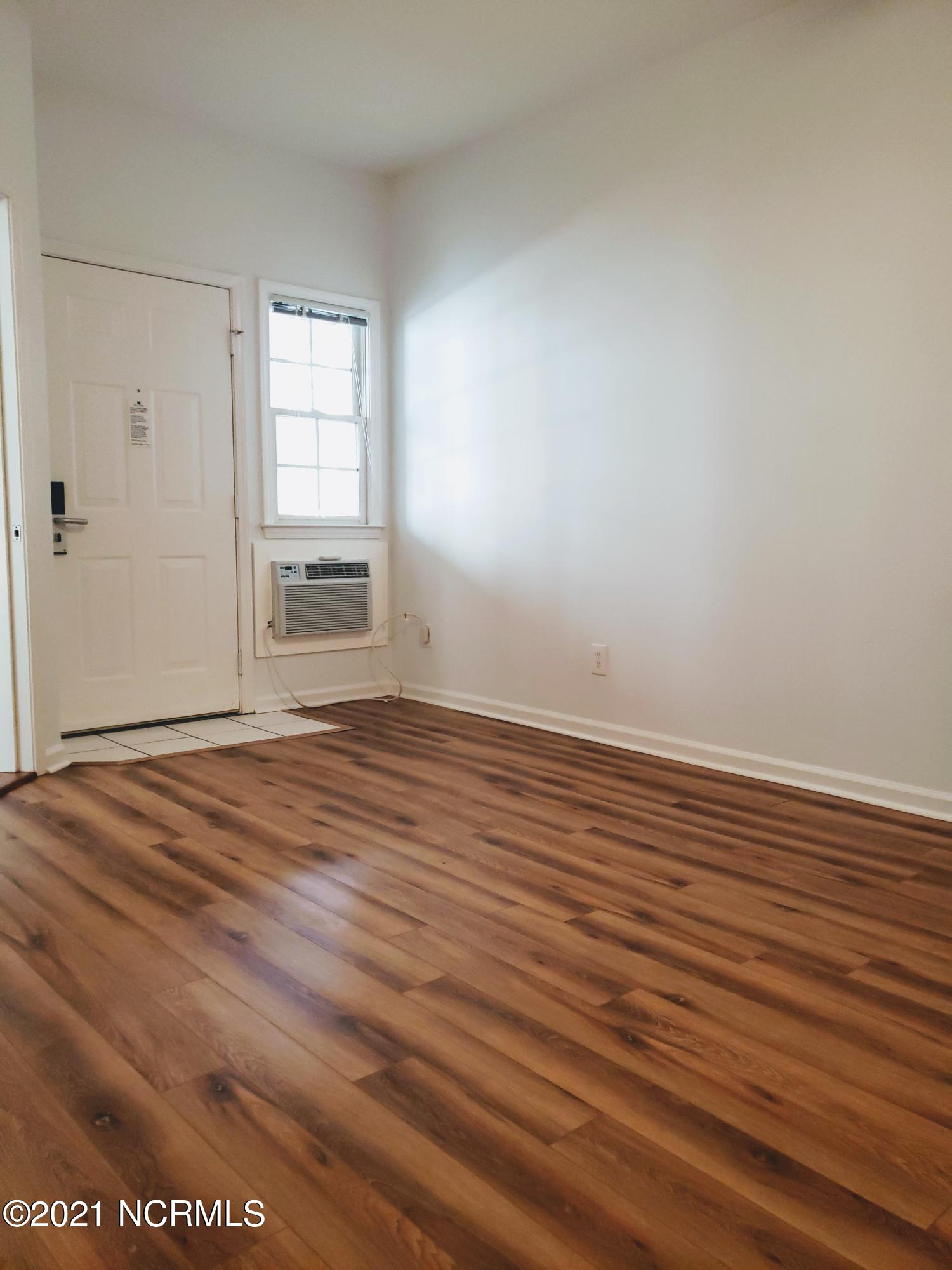 155 Royal Poste Road, Unit 3002 Sunset Beach, NC 28468 - Photo 11 of 20 Lock-out unit with NEW LVP Flooring and NEW Heat/AC Wall Unit.